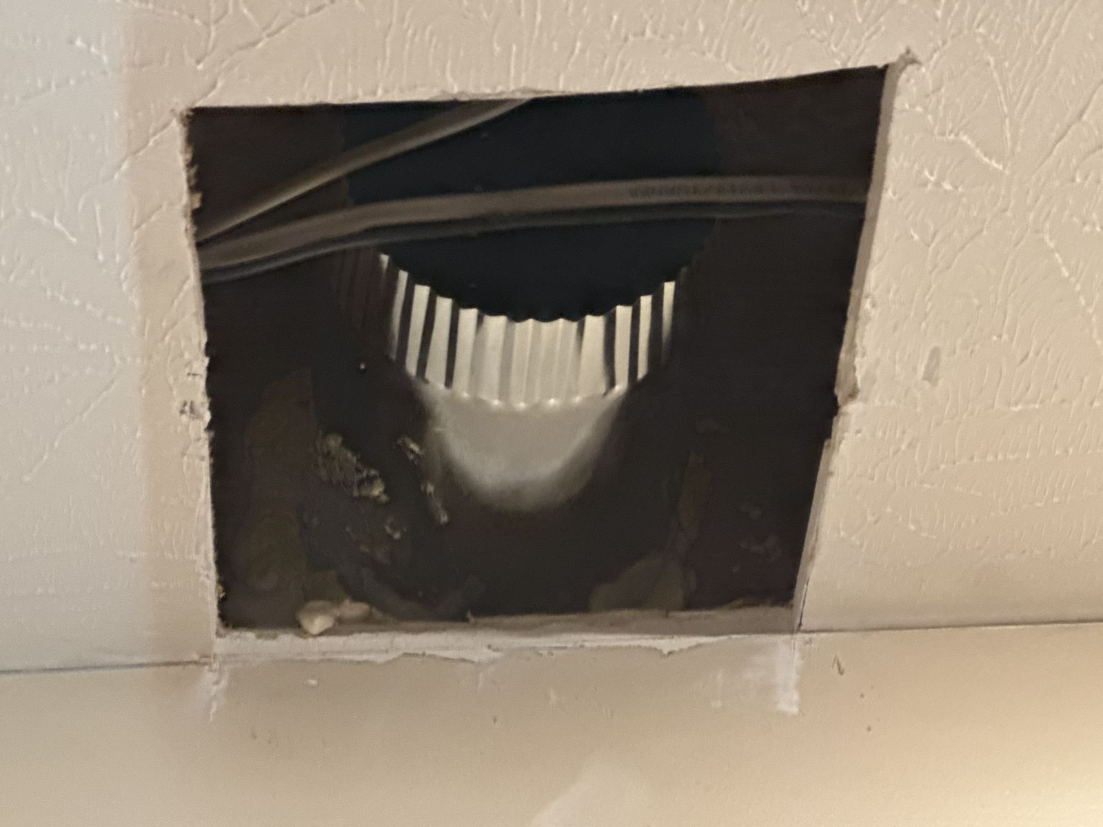Ceiling cut-out with the range hood exhaust duct connected