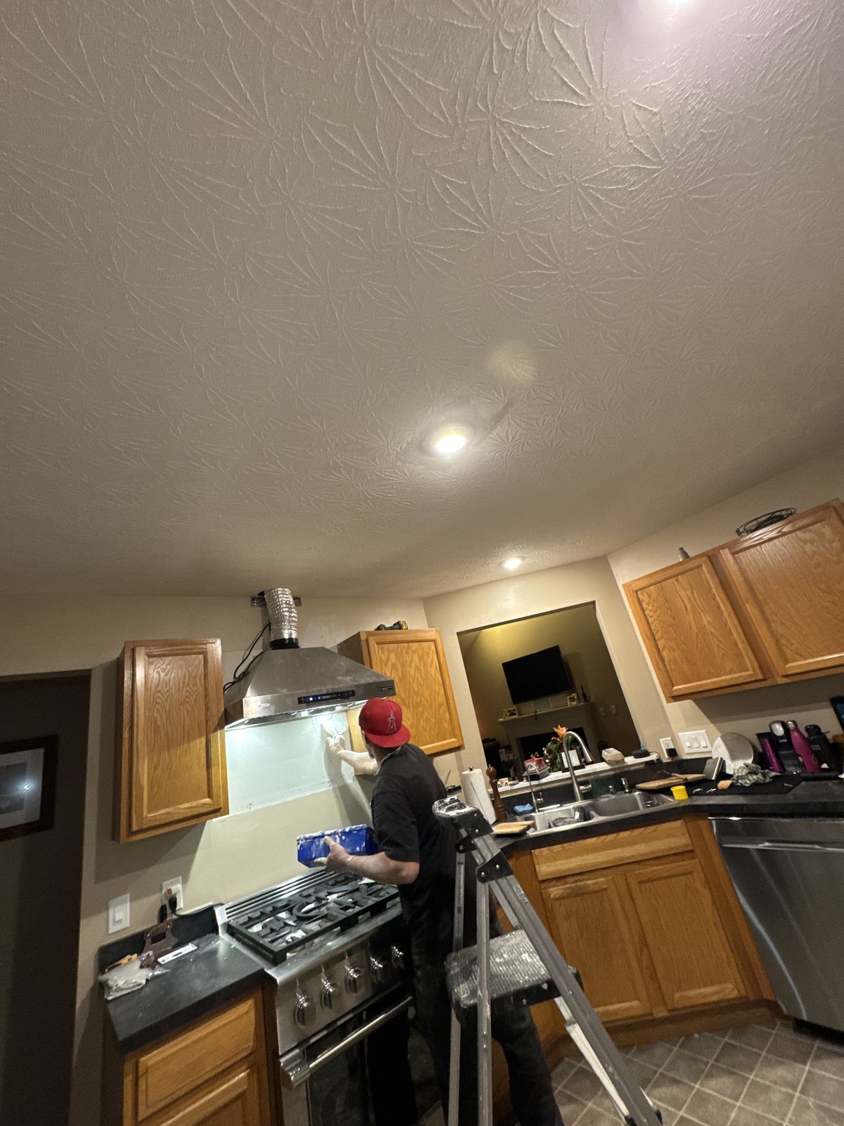 Final check on a new range hood installation in the kitchen
