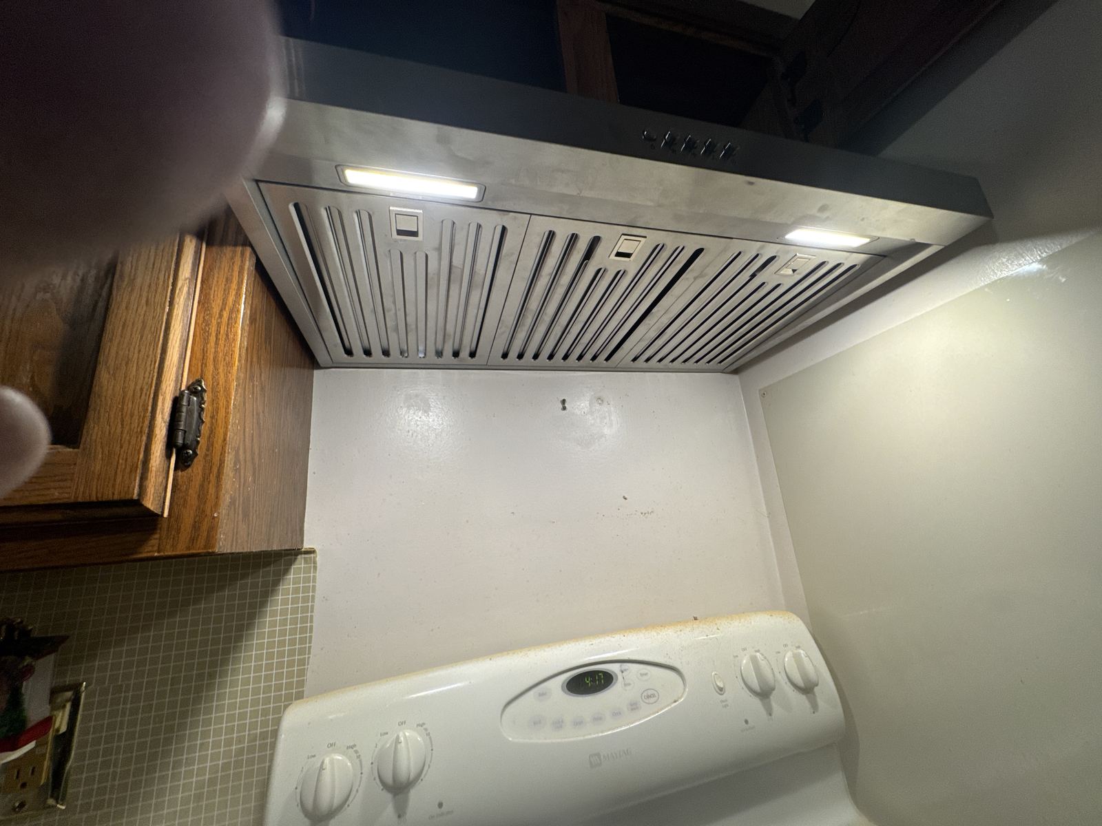 Finished under-cabinet range hood with lights on
