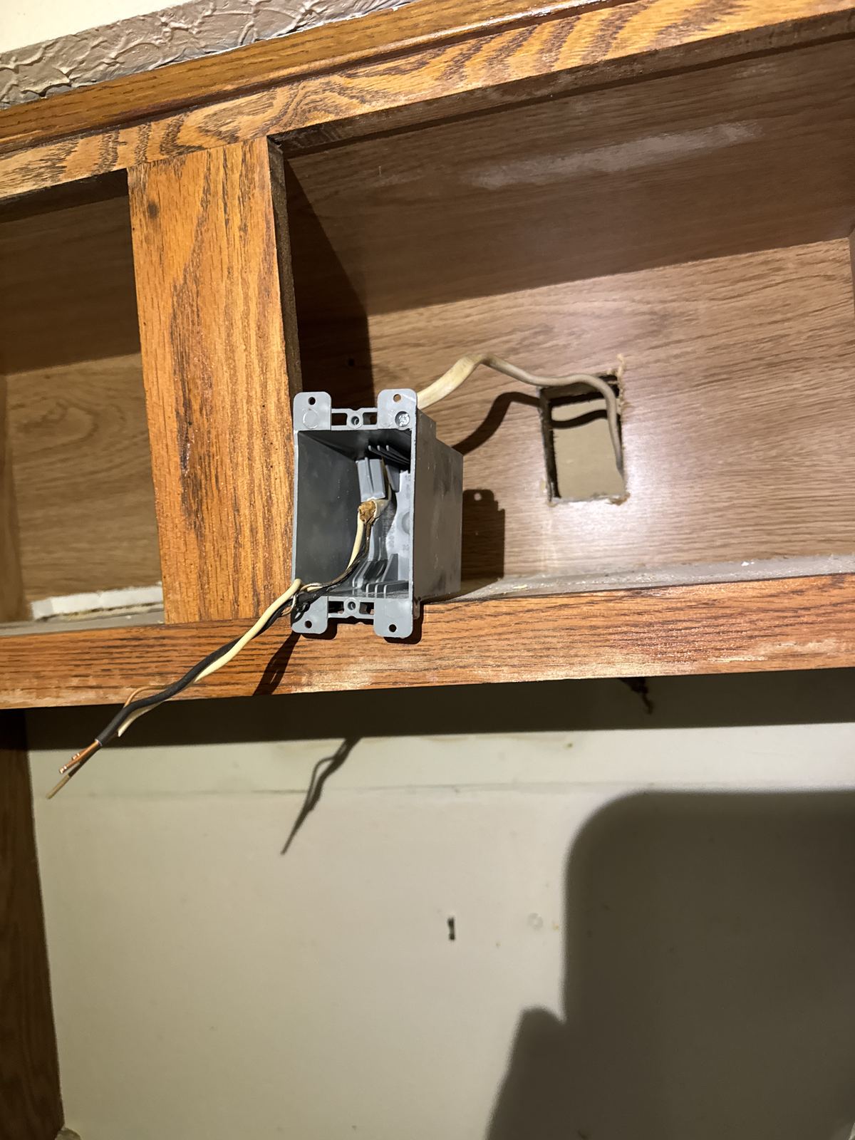 New electrical box installed inside the cabinet for the range hood
