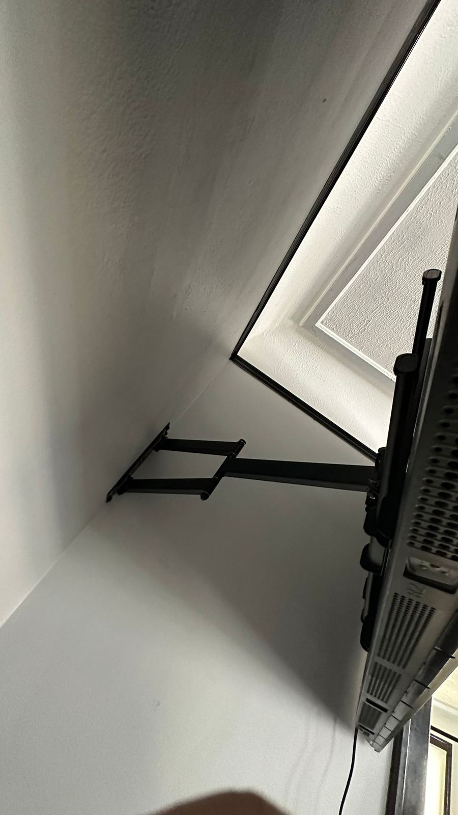 Full-motion articulating TV mount extended from the wall