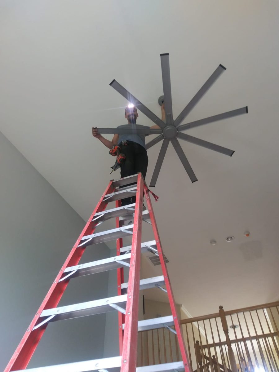 Large modern ceiling fan installed in a vaulted ceiling