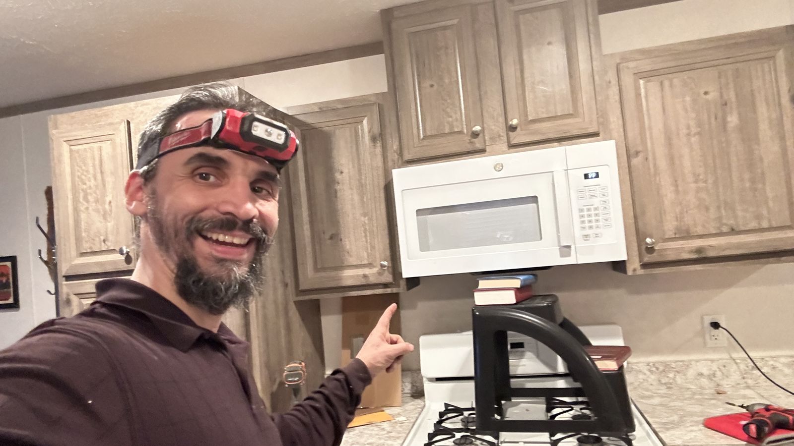 New over-the-range microwave installed above a gas range