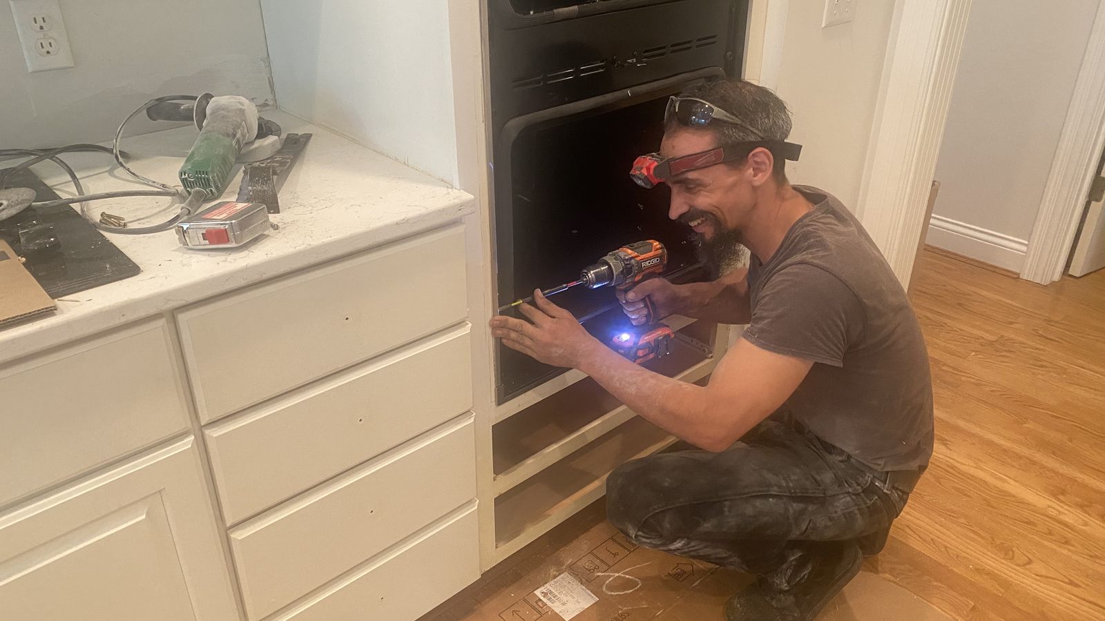 Installing a built-in kitchen wall oven, working inside the cabinet