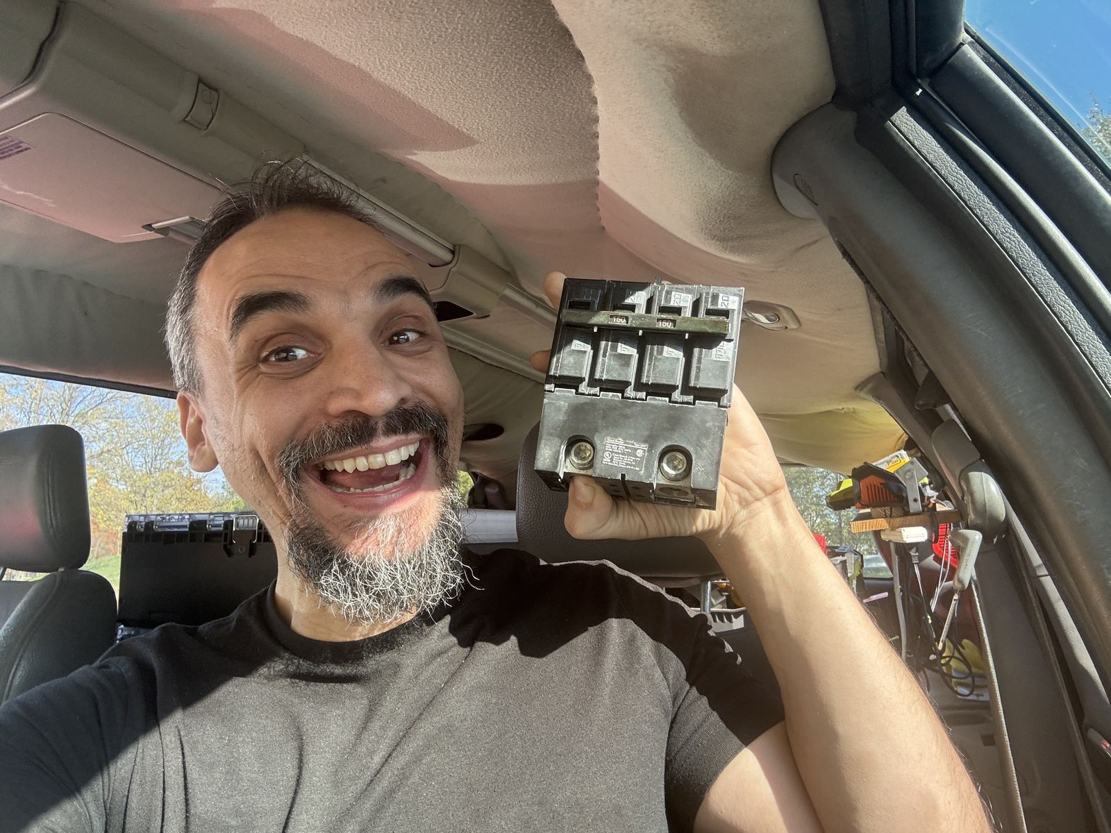 Gabriel holding a replacement circuit breaker