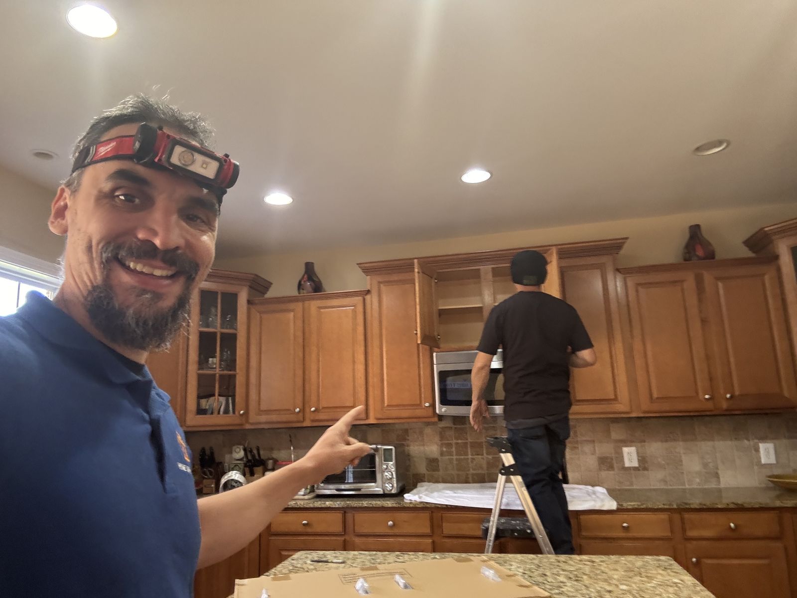 Gabriel pointing to a kitchen ceiling light install