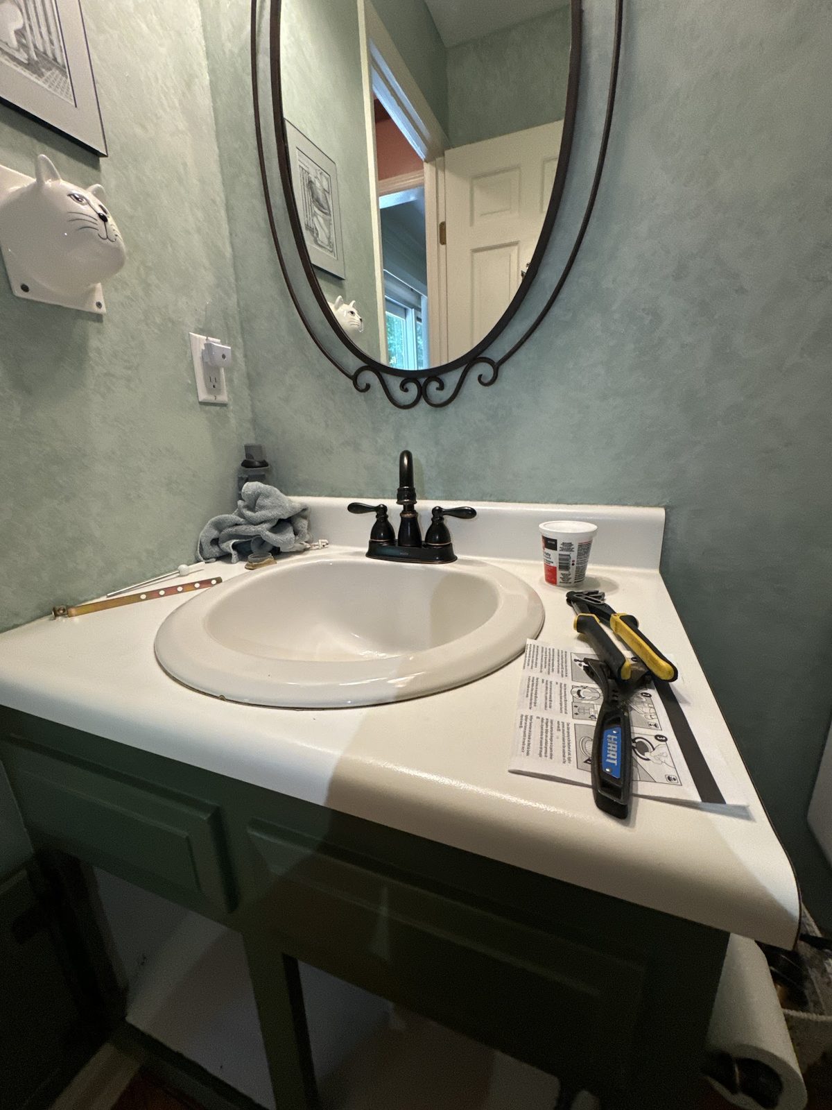 Bathroom vanity sink and faucet install with tools on the counter