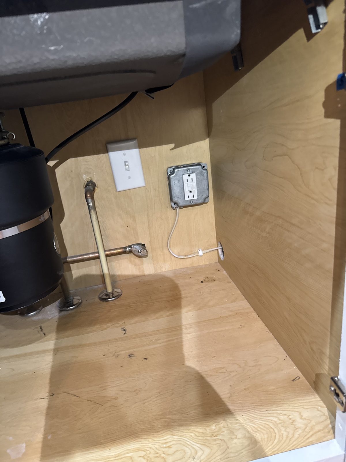 Under-sink water supply lines and disposal in a cleared cabinet
