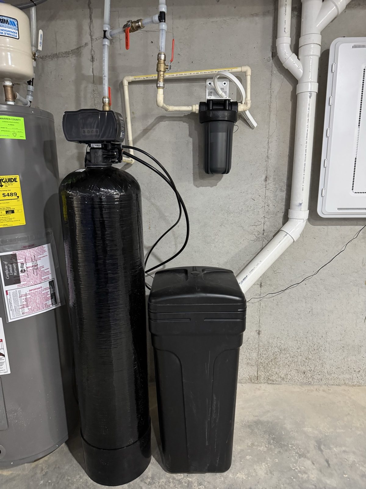 Water softener, brine tank and sediment filter installed next to a water heater by Gabriel, Your Job Done Now