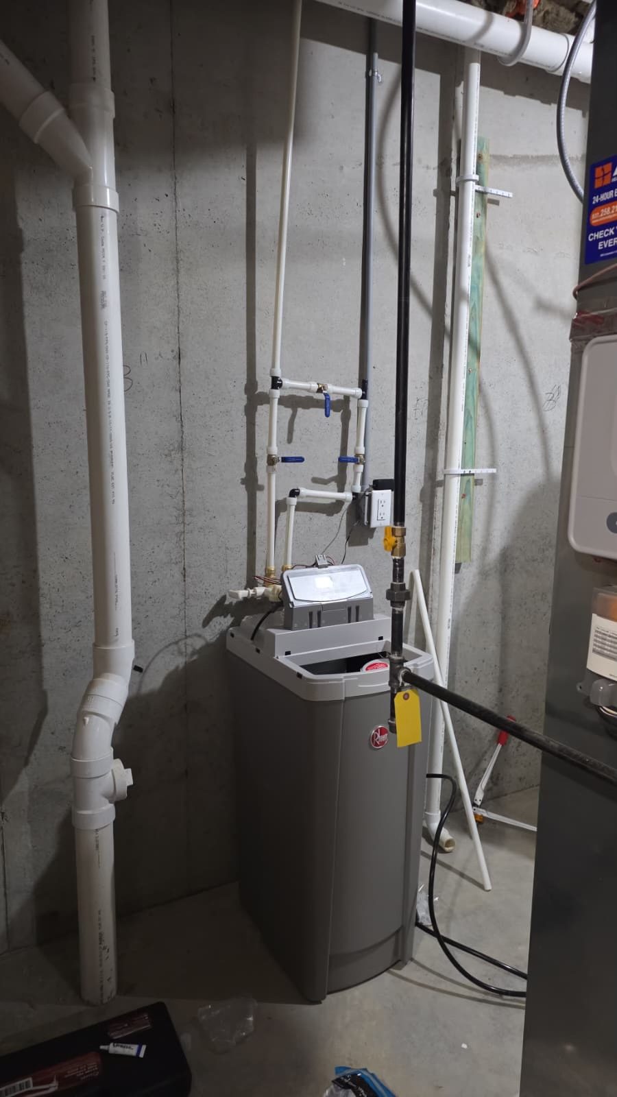 All-in-one water softener installed in an unfinished basement by Gabriel, Your Job Done Now