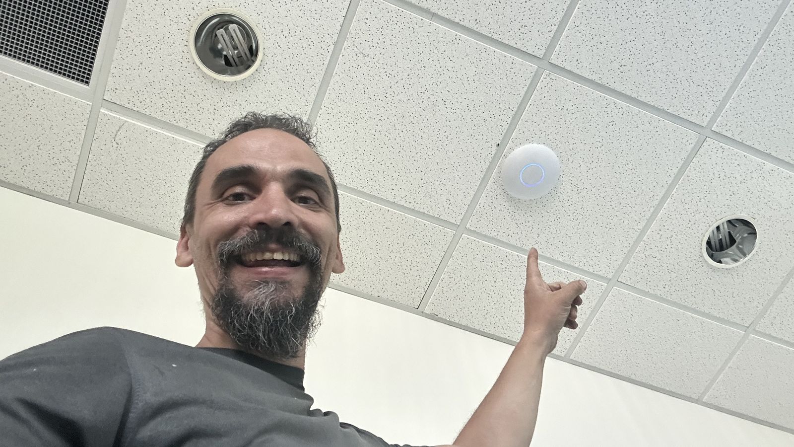 Gabriel next to a ceiling-mounted security camera