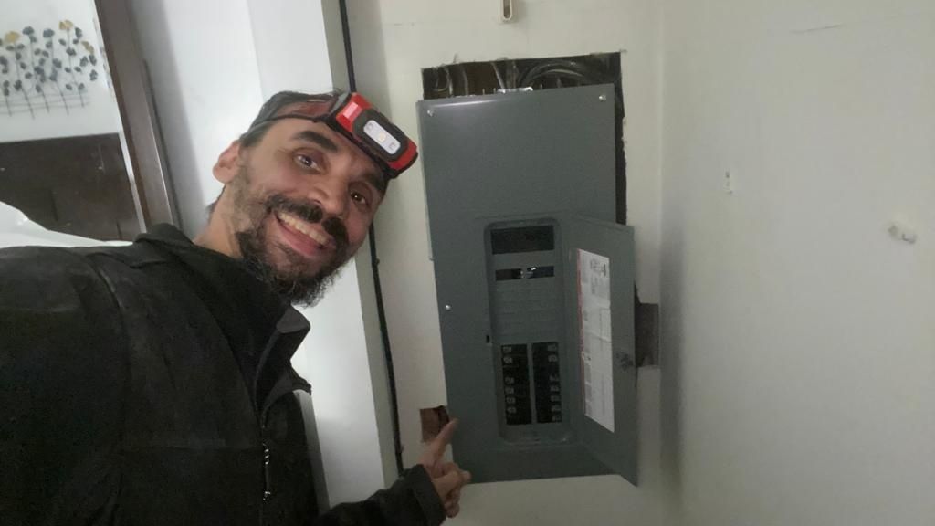 Gabriel next to a breaker panel install