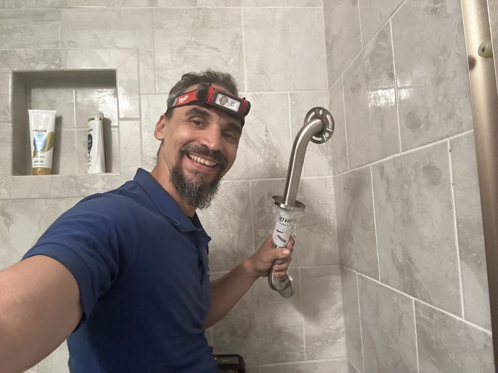 Shower grab bar installed into tile wall